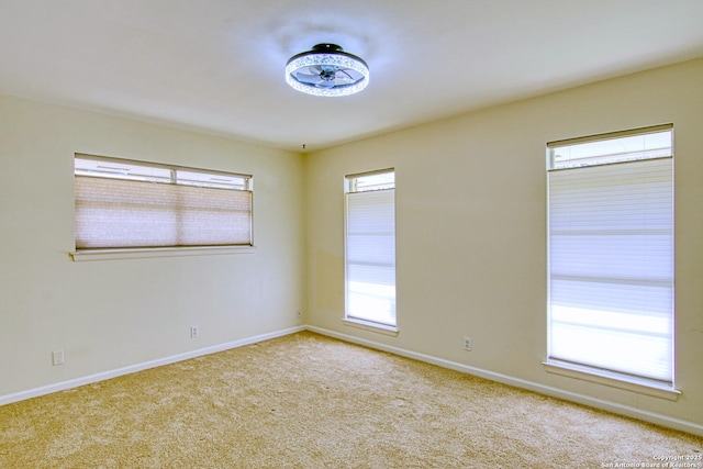 unfurnished room featuring carpet floors and baseboards