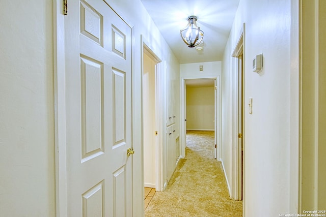 hallway featuring light colored carpet