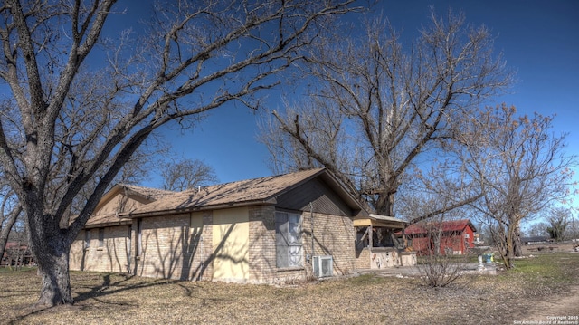 view of side of home with central AC