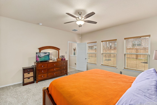 bedroom featuring ceiling fan, visible vents, baseboards, and light colored carpet