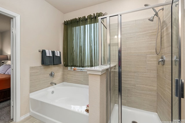 ensuite bathroom with a garden tub, connected bathroom, and a shower stall