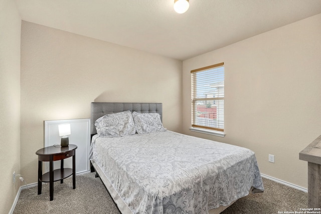 bedroom featuring carpet floors and baseboards