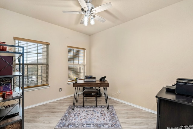 office area featuring light wood-style flooring, baseboards, and ceiling fan