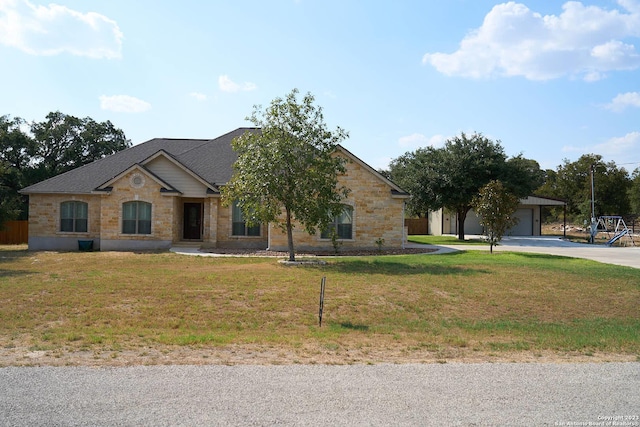 ranch-style house with stone siding and a front yard