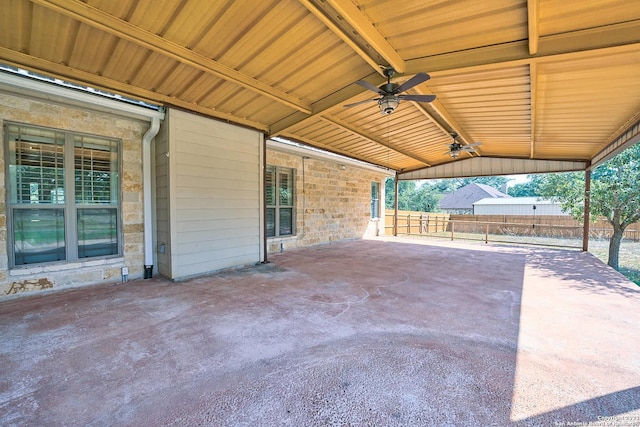 view of patio featuring ceiling fan, a carport, and fence