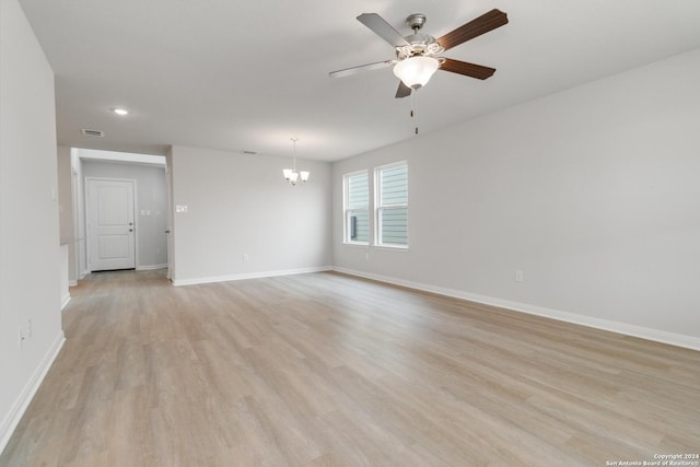 unfurnished room featuring ceiling fan with notable chandelier, recessed lighting, baseboards, and light wood-style floors