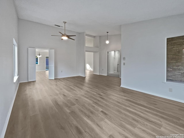 unfurnished living room featuring light wood-style flooring and baseboards