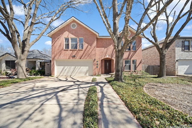 traditional home featuring concrete driveway, brick siding, fence, and an attached garage