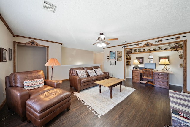 living room with visible vents, dark wood finished floors, a textured ceiling, and ornamental molding