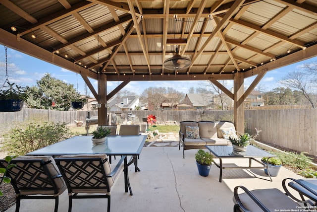 view of patio / terrace with a gazebo, outdoor dining area, a fenced backyard, and an outdoor living space