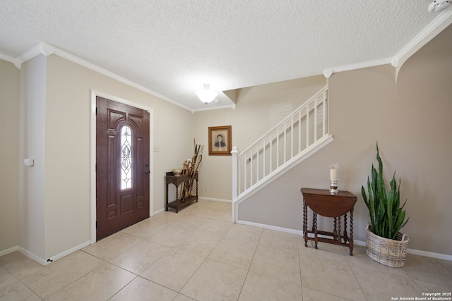 tiled foyer entrance with a textured ceiling, stairway, and crown molding