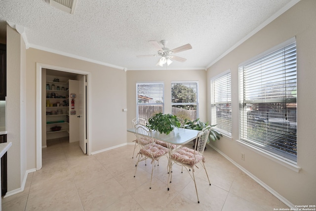 dining area featuring ornamental molding, visible vents, a textured ceiling, and light tile patterned floors