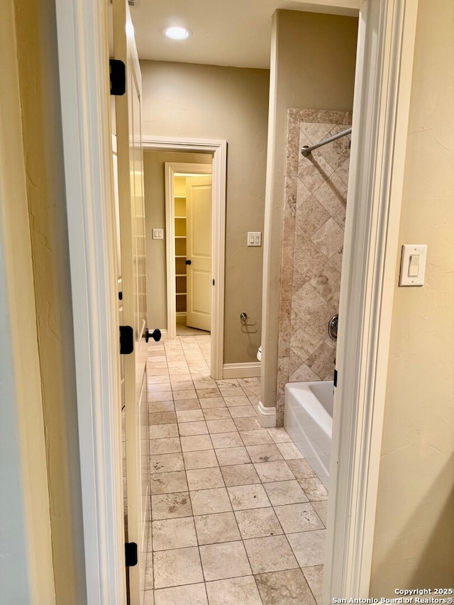 bathroom with  shower combination, baseboards, toilet, and tile patterned floors