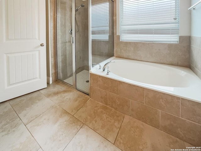 full bathroom with a stall shower, a bath, and tile patterned floors