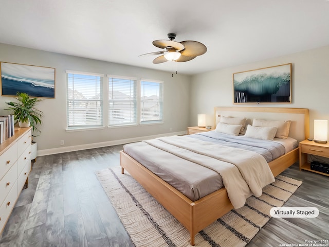 bedroom featuring ceiling fan, wood finished floors, and baseboards