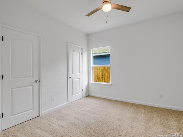 unfurnished bedroom with carpet, ceiling fan, and baseboards