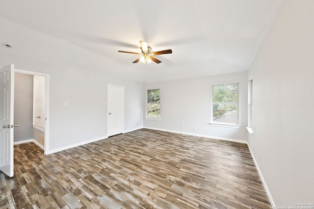 spare room featuring ceiling fan, baseboards, and wood finished floors