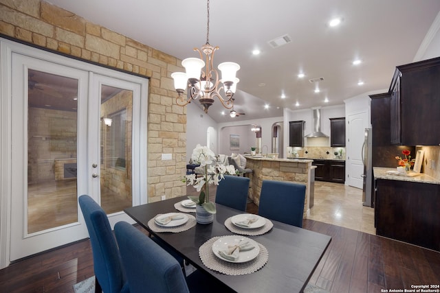 dining room with an inviting chandelier, light wood-style flooring, visible vents, and french doors