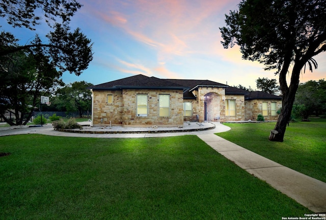 view of front of home featuring stone siding and a front yard