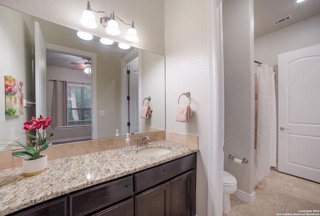 bathroom featuring visible vents, toilet, a ceiling fan, vanity, and tile patterned floors