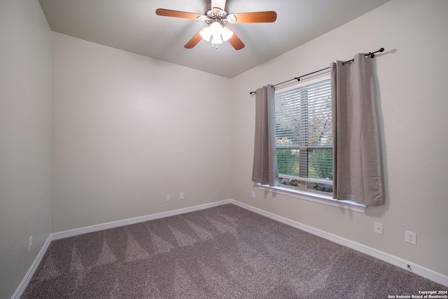 spare room with carpet floors, ceiling fan, and baseboards