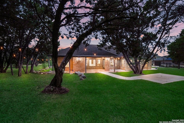 exterior space featuring stone siding and a yard