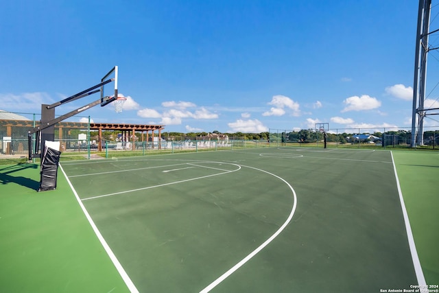 view of basketball court featuring community basketball court and fence