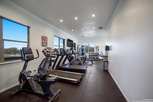 exercise room with plenty of natural light, baseboards, and recessed lighting