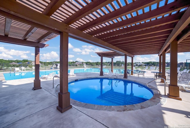 community pool with a patio, fence, and a pergola