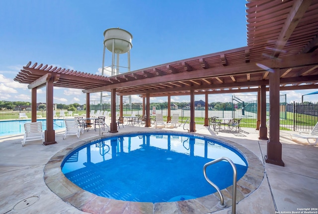 community pool with fence, a pergola, and a patio