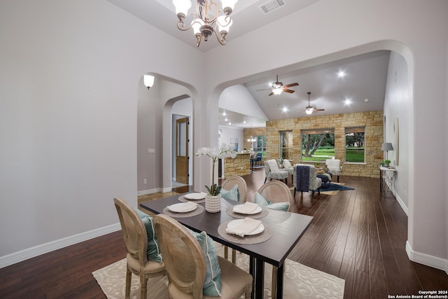 dining space with arched walkways, hardwood / wood-style flooring, visible vents, and a notable chandelier