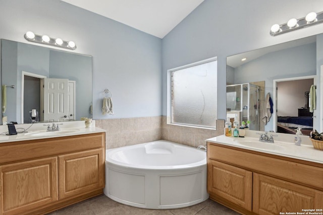 ensuite bathroom featuring a stall shower, a sink, a bath, and tile patterned floors