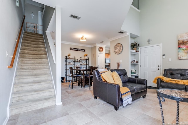 living room with light tile patterned floors, visible vents, stairway, and crown molding