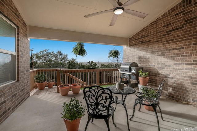 wooden deck with ceiling fan and a grill