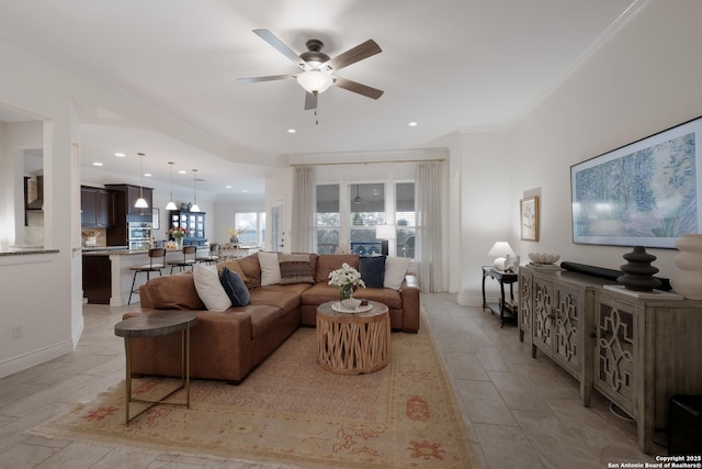 living room featuring ornamental molding, recessed lighting, baseboards, and a ceiling fan