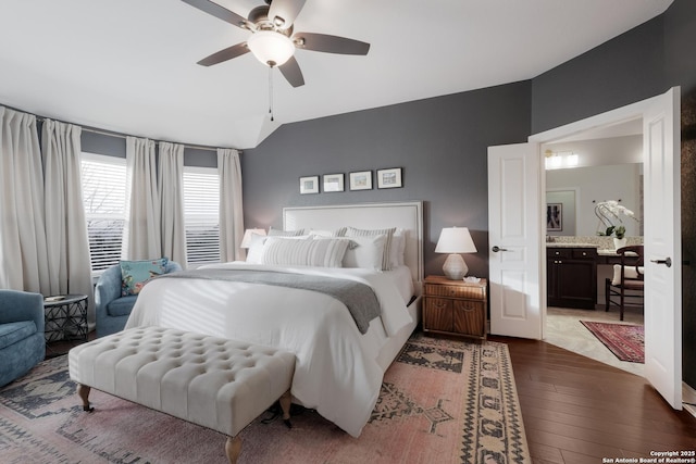 bedroom with lofted ceiling, ceiling fan, and dark wood-type flooring