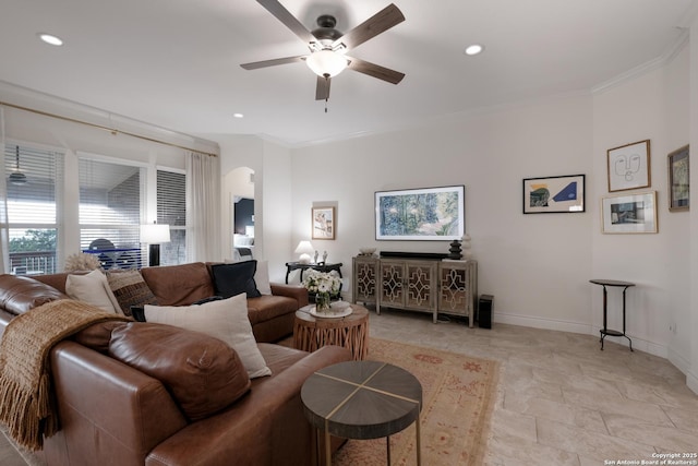 living area with arched walkways, ornamental molding, recessed lighting, and baseboards