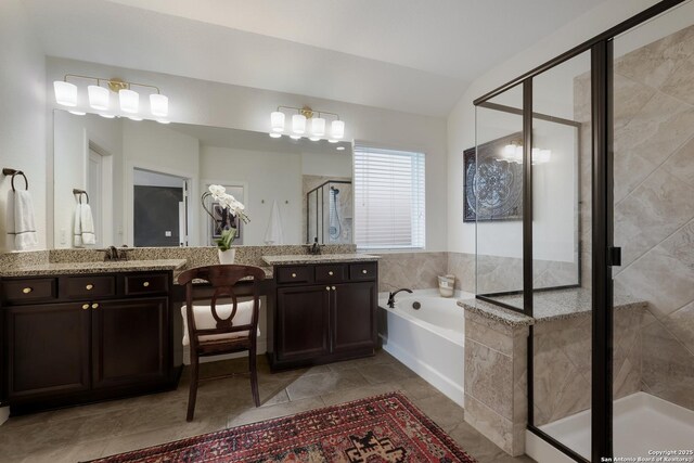 full bathroom featuring a stall shower, a garden tub, vaulted ceiling, and vanity