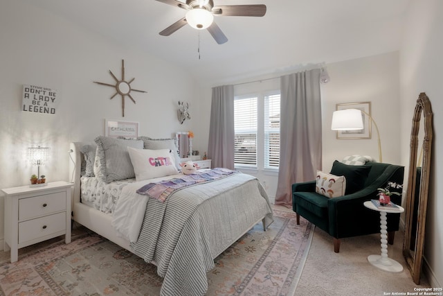 bedroom featuring vaulted ceiling, a ceiling fan, and light colored carpet