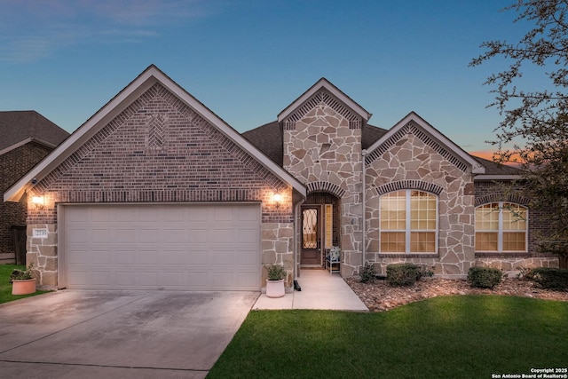 view of front of home featuring a garage, stone siding, brick siding, and concrete driveway