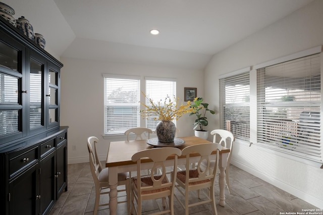 dining room with lofted ceiling, recessed lighting, and baseboards