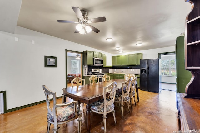 dining area with a ceiling fan and baseboards