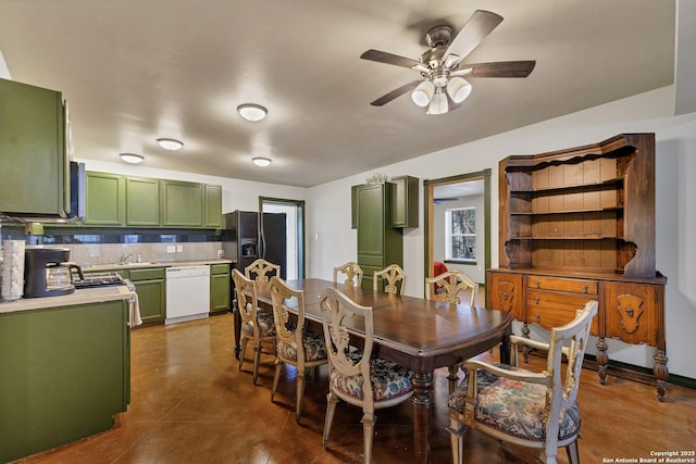 dining area with concrete flooring and a ceiling fan