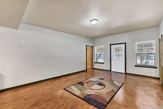 unfurnished room featuring baseboards