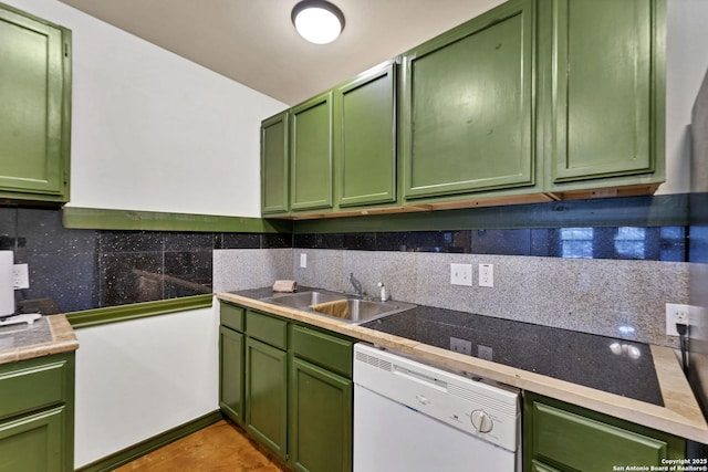 kitchen with a sink, white dishwasher, decorative backsplash, and green cabinetry