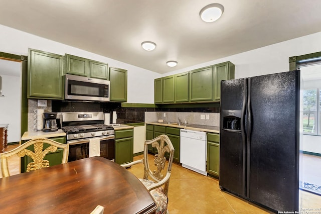 kitchen with appliances with stainless steel finishes, green cabinetry, and decorative backsplash