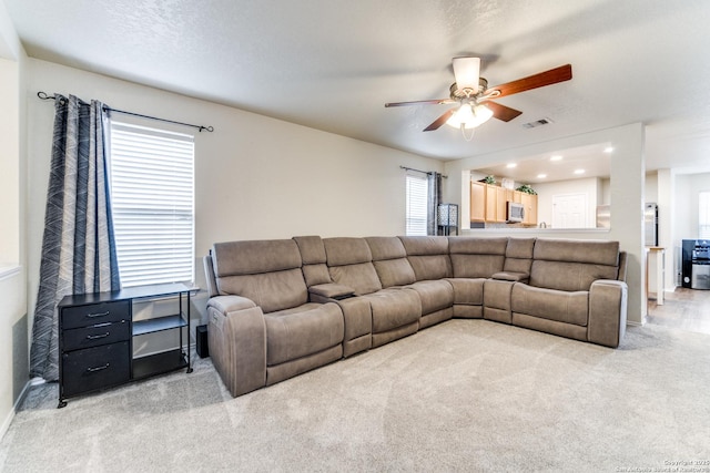 living area with recessed lighting, light colored carpet, visible vents, ceiling fan, and a textured ceiling