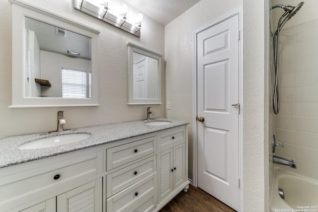 16110 Ambush Grv, San Antonio, TX 78247 - bathroom with double vanity, visible vents, wood finished floors, and a sink