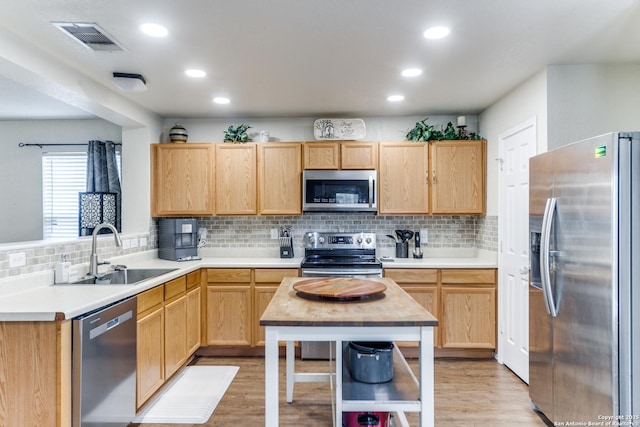 16110 Ambush Grv, San Antonio, TX 78247 - kitchen with visible vents, light brown cabinets, stainless steel appliances, and a sink