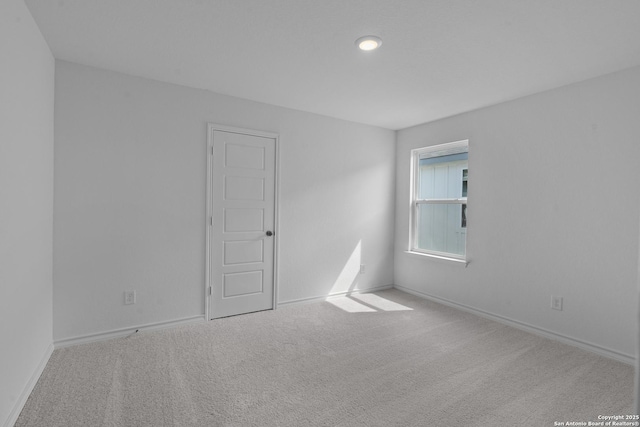 spare room with carpet flooring and baseboards
